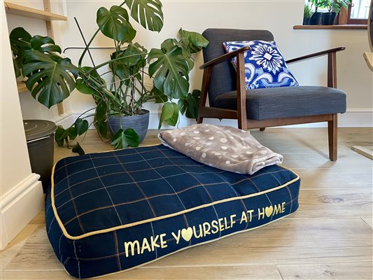 large navy dog bed with the words 